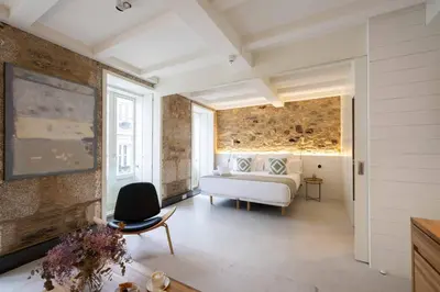 a bedroom with a bed and a couch in a room at The Tailor's Garden in Santiago de Compostela