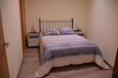 a large bed in a bedroom with two night stands at Casa Galegos in Pantón