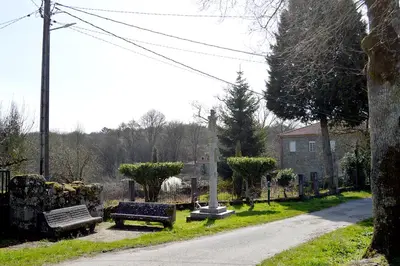 a group of benches sitting in a park at Casa Galegos in Pantón