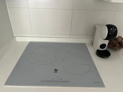 a kitchen with a white counter top with a coffee maker at Apartamento con terraza,2 min de la playa, Ares in Ares