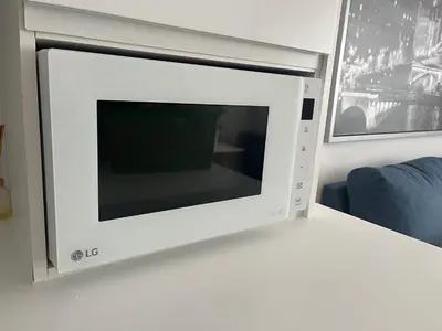 a microwave oven sitting on top of a wall at Apartamento con terraza,2 min de la playa, Ares in Ares