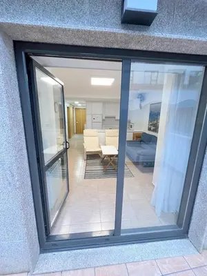 a window with a view of a living room at Apartamento con terraza,2 min de la playa, Ares in Ares