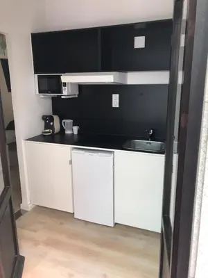 a kitchen with white cabinets and a sink at Nest Flats Santiago VUT in Santiago de Compostela