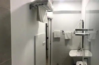 a white bathroom with a sink and a toilet at Nest Flats Santiago VUT in Santiago de Compostela