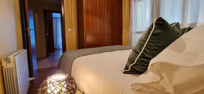 a bedroom with a bed with two pillows on it at Apartamento Inma in Silleda
