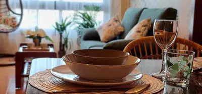 a bowl on a plate on a table with a wine glass at Apartamento Inma in Silleda