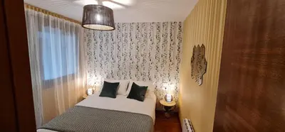 a small bedroom with a bed and a window at Apartamento Inma in Silleda