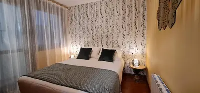 a small bedroom with a bed and a window at Apartamento Inma in Silleda