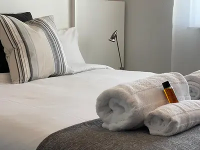 a bedroom with a bed with a towel on it at Oktheway Rua Nova 3D in Sarria