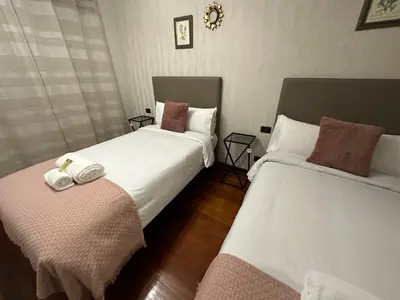 a bedroom with two beds with towels on them at Oktheway Rua Nova 3D in Sarria