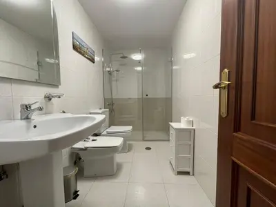 a bathroom with a sink and a toilet and a shower at Oktheway Rua Nova 3D in Sarria