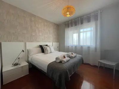 a bedroom with a bed with two stuffed animals on it at Oktheway Rua Nova 3D in Sarria