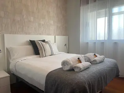 a bedroom with a large bed with towels on it at Oktheway Rua Nova 3D in Sarria