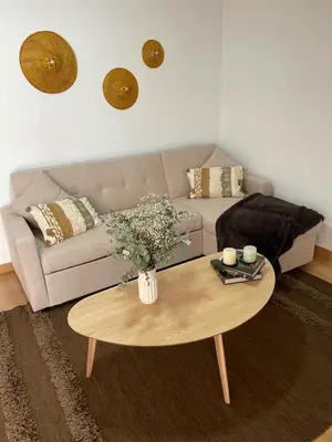 a living room with a couch and a coffee table at O Pequeno Rincón in Allariz