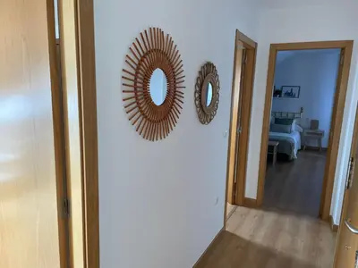 a hallway with two mirrors on a white wall at O Pequeno Rincón in Allariz