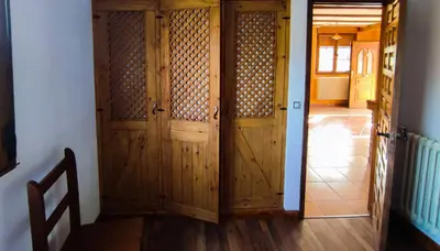 a wooden door in a room with a hallway at A Porteliña Casa Rural, entre viñedos y castaños in Ambas Aguas