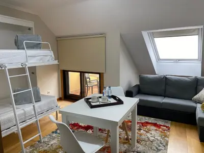 a living room with a bunk bed and a couch at O SECRETO in Padrón