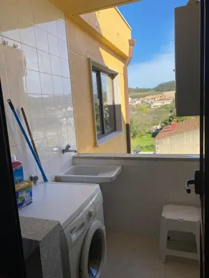 a bathroom with a washing machine and a window at O SECRETO in Padrón