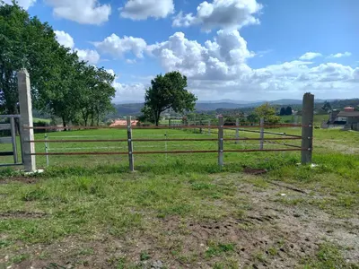 a fence in the middle of a field at Hotel La Puerta de Arzúa in Arzúa