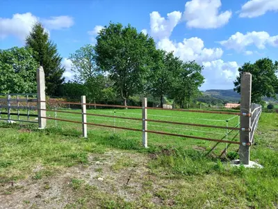 a fence in the middle of a field at Hotel La Puerta de Arzúa in Arzúa