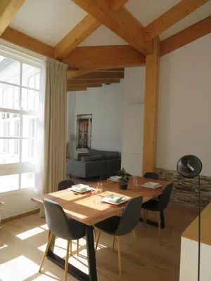 a living room with a wooden table and chairs at APARTAMENTOS ARMANYA 3 in Lugo