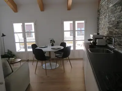a kitchen with a table and chairs and a sink at APARTAMENTOS ARMANYA 3 in Lugo