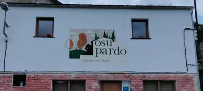 a billboard on the side of a building at Casa Osu Pardo VuT in Caboalles de Abajo