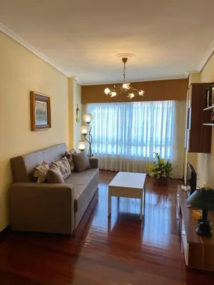 a living room with a couch and a table at Casa Goros I in Melide