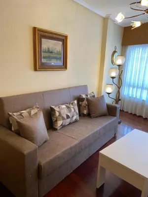 a living room with a couch and a table at Casa Goros I in Melide
