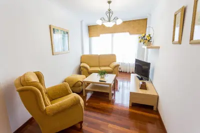 a living room with two chairs and a tv at Casa Goros II in Melide