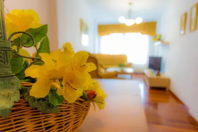 a basket with yellow flowers in a living room at Casa Goros II in Melide
