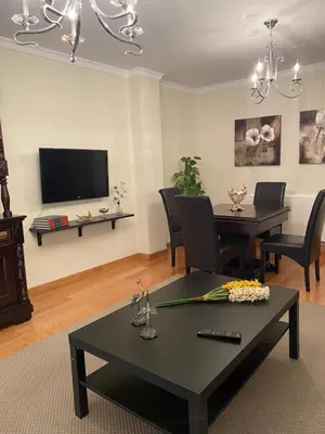 a living room with a table and a tv at Casa Goros in Melide