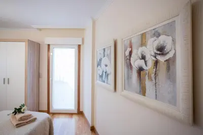 a bedroom with two pictures on the wall at Casa Goros in Melide