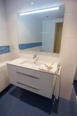 a bathroom with a white sink and a mirror at Casa Goros in Melide