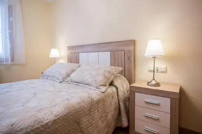a bedroom with a bed and a night stand with a lamp at Casa Goros in Melide