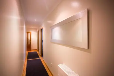 a hallway with a large painting on the wall at Casa Goros in Melide
