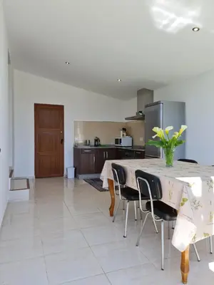 a kitchen with a table and chairs in a room at Chalet do Médico in Rodeiro