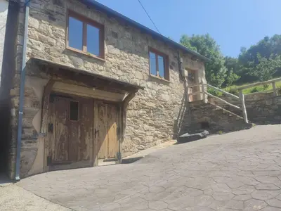 a stone building with a wooden door and a staircase at Casas Eladio-Doncos in Torés