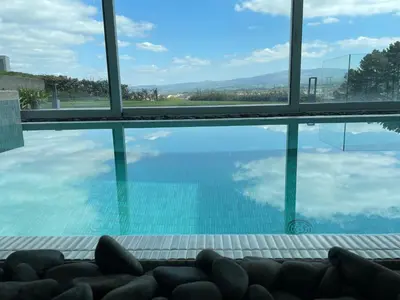 a swimming pool with a view of the water at Tres Prismas Exclusive in Sarria