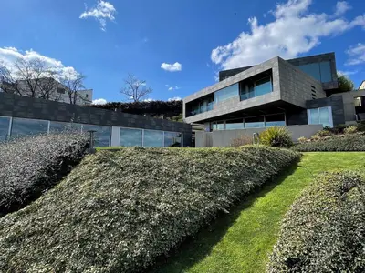 a house with a hedge in front of it at Tres Prismas Exclusive in Sarria