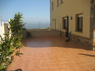 a large patio with a view of the ocean at Tapia in Tapia de Casariego