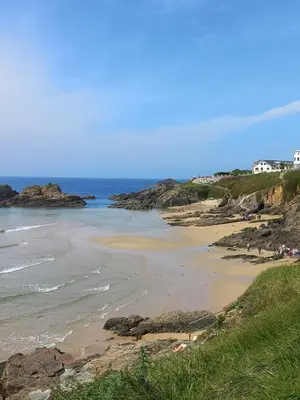 a beach with a group of people on the shore at Tapia in Tapia de Casariego