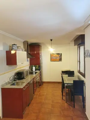 a kitchen with a table and a dining room at Tapia in Tapia de Casariego