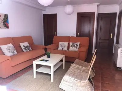 a living room with a couch and a table at Tapia in Tapia de Casariego