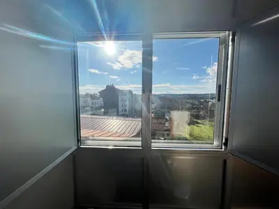 a window with a view of a city at Pensión Carballeira in Arzúa