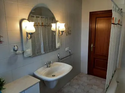 a bathroom with a sink and a mirror at Apartamento AS CARBALLAS in Caldas de Reis