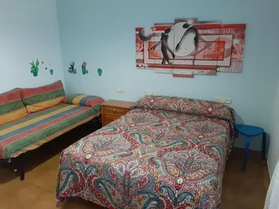 a bedroom with a bed and a bed and a table at Apartamento AS CARBALLAS in Caldas de Reis