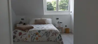 a white bedroom with a bed and a window at Avante24 in Puentedeume