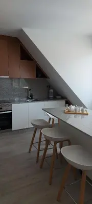 a kitchen with a table and chairs and a staircase at Avante24 in Puentedeume