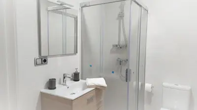 a white bathroom with a sink and a shower at Avante24 in Puentedeume